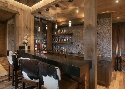 Bar with Custom cowhide upholstered bar stools compliment this well stocked bar in Blairsville Georgia.