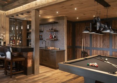 Mushroom wood walls add a rustic textural element to this game room and bar in Blairsville Georgia.