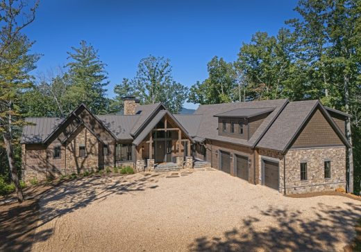 Blue Mist Custom Home Front 1. Stone, hewn log siding, board and batten and shakes clad Blue Mist Lodge, to give it a classic yet rustic custom home style in Blairsville Georgia