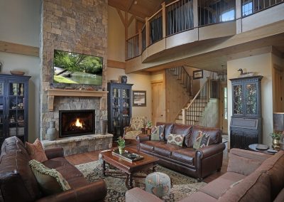The loft's radiused railing overlooks the great room. Blue Ridge, Georgia