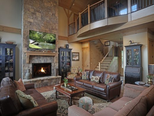 The loft's radiused railing overlooks the great room. Blue Ridge, Georgia