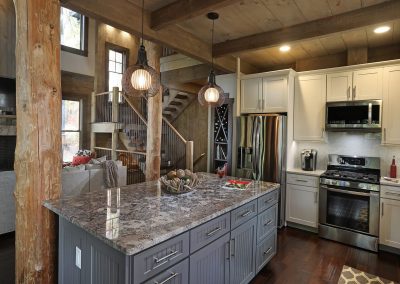 Open concept kitchen island overlooking vaulted great room in Jasper, Georgia by Modern Rustic Homes