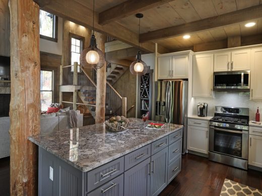 Open concept kitchen island overlooking vaulted great room in Jasper, Georgia by Modern Rustic Homes