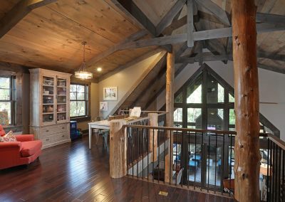 Rustic loft overlooking great room interior in Jasper, Georgia by Modern Rustic Homes