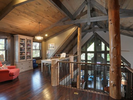 Rustic loft overlooking great room interior in Jasper, Georgia by Modern Rustic Homes