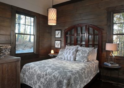 Rustic primary bedroom interior with natural wood finishes in Jasper, Georgia by Modern Rustic Homes