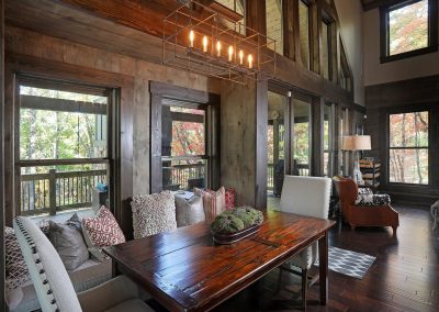 Rustic dining nook with window seat banquette in Jasper, Georgia by Modern Rustic Homes